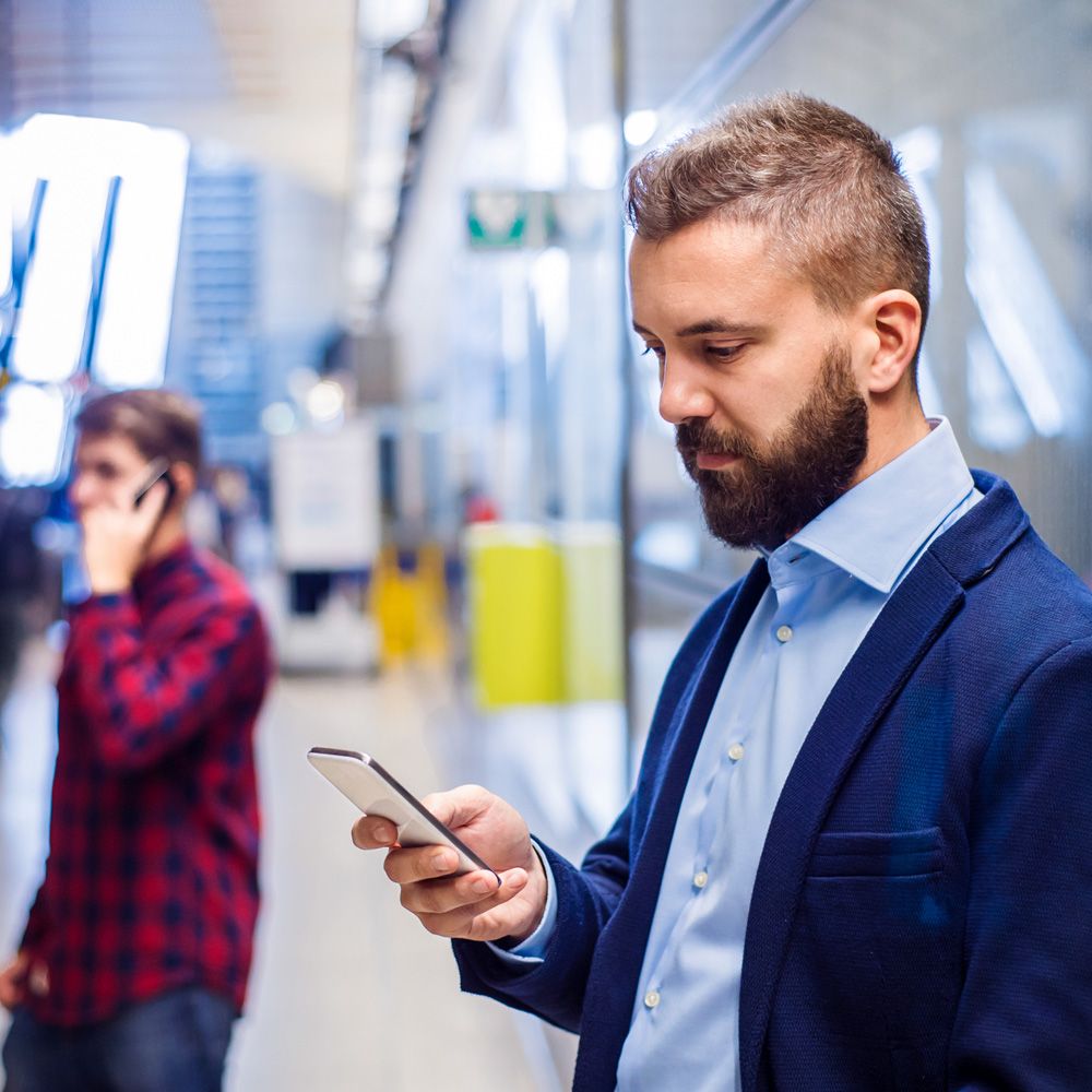 A business man accessing data via a mobile phone